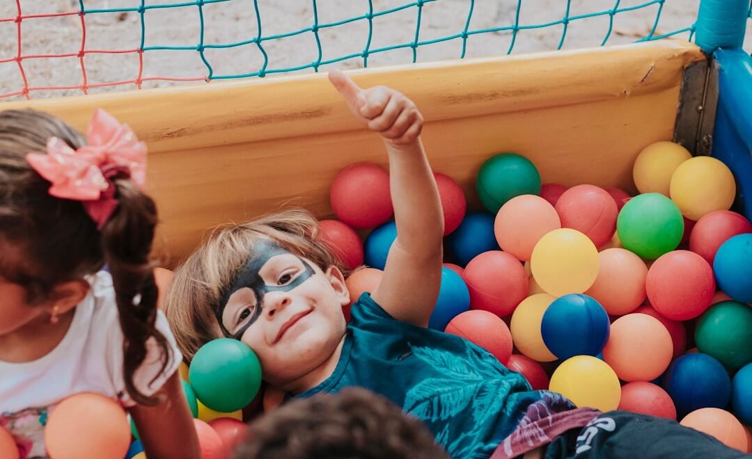 girl in blue shirt lying on yellow inflatable pool