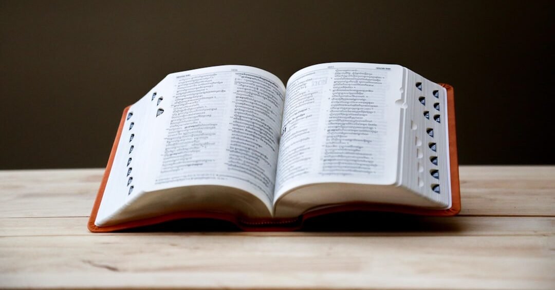 opened book on brown table