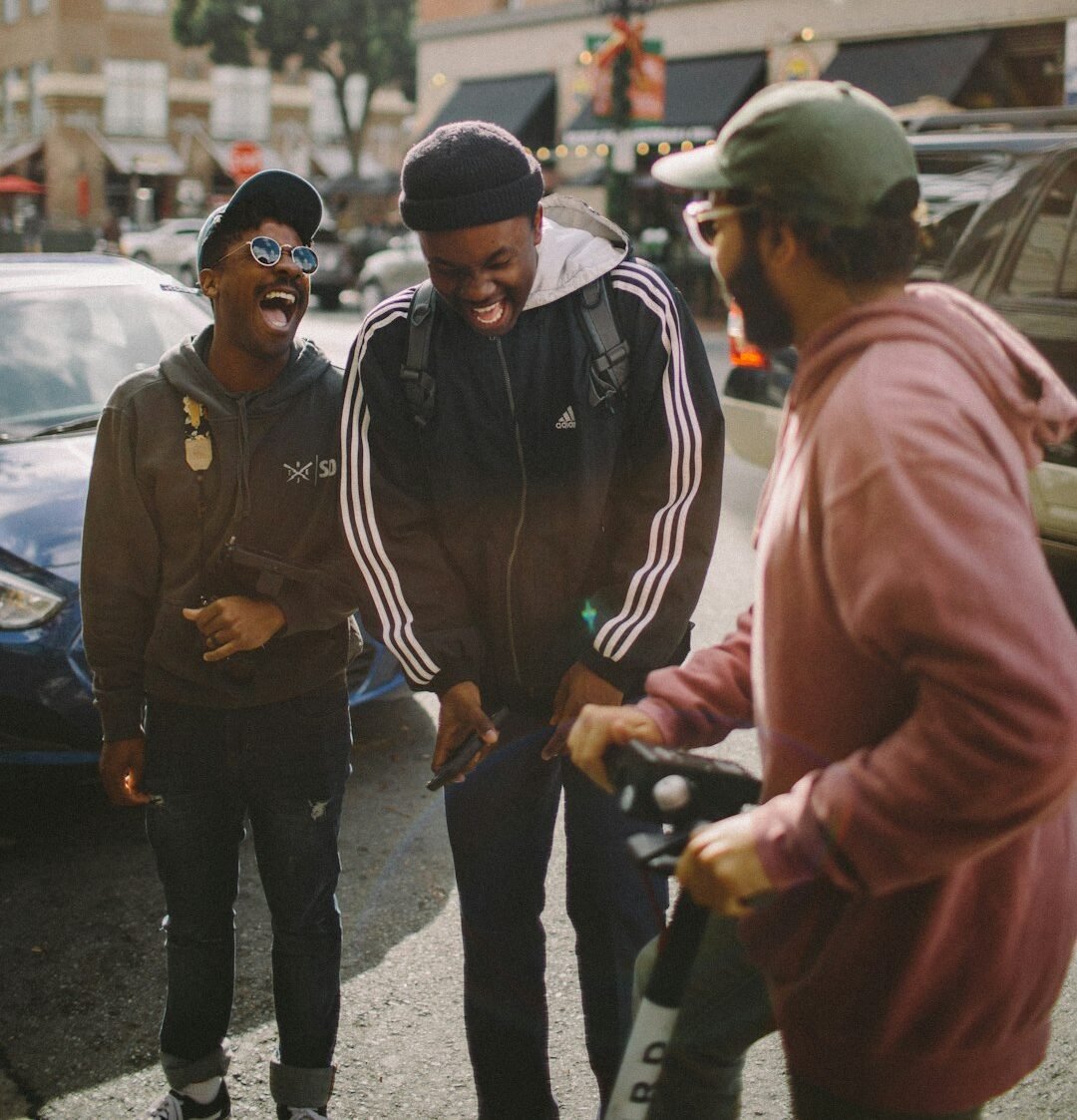 three men in jacket laughing at each other